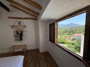 a room with a window and a bed with a view at El Rincón de Laura - Quesada in Quesada