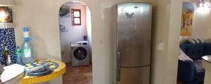 a kitchen with a refrigerator and a washing machine at Villa Les Flamboyants in Somone