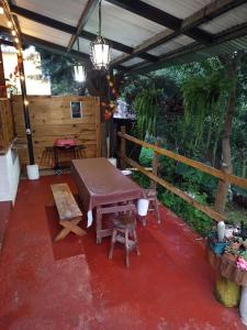 a patio with a table and chairs and a fence at Granja Triple A in Guatemala