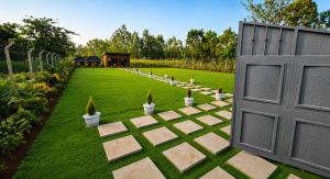 a garden with a gate and a lawn with potted plants at The Blair Luxury in Paulo