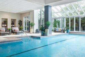 a swimming pool in a building with a conservatory at Renaissance Austin Arboretum Domain Hotel in Austin