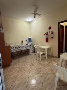 a waiting room with a table and chairs at Pousada Flor do Vale in São José dos Campos +19 photos