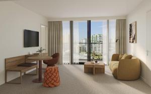 a living room with a couch and a tv at Quest on Wickham Terrace in Brisbane