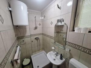 a small bathroom with a sink and a mirror at Villa Tira in Jajce +13 photos