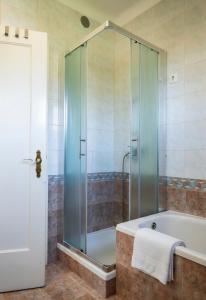 a bathroom with a tub and a glass shower at Entire Villa for 6 near Bled -Private Garden, Grill & Free Parking in Lesce +40 photos