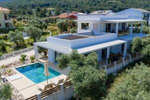 an aerial view of a house with a swimming pool at Oasis deluxe apartments in Skala Rachoniou