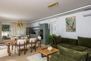a living room with a couch and a table at Oasis deluxe apartments in Skala Rachoniou