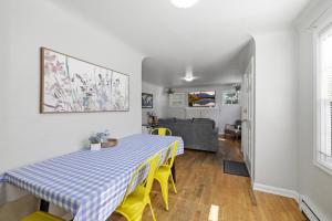a dining room with a table and yellow chairs at Charming 1930s Style Rustic Home in Eugene +22 photos