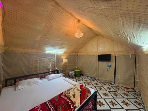 a bedroom with a bed in a tent at Bagan Bilas Homestay in Jhilimili