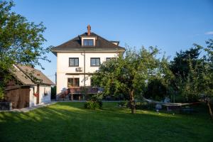 a large white house with a yard with trees at Entire Villa for 6 near Bled -Private Garden, Grill & Free Parking in Lesce