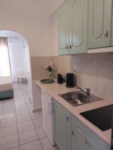 a kitchen with a sink and a counter top at Maria Studios in Paleokastritsa