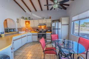 a kitchen with a glass table and red chairs at MarBrisas 3 Bed 2 Bath in Puerto Peñasco