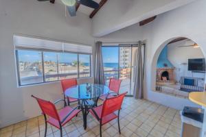 a dining room with a table and chairs and a fireplace at MarBrisas 3 Bed 2 Bath in Puerto Peñasco