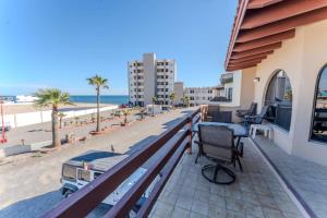 a balcony with a bench and the beach at MarBrisas 3 Bed 2 Bath in Puerto Peñasco