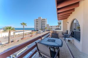 a balcony with tables and chairs and the beach at MarBrisas 3 Bed 2 Bath in Puerto Peñasco