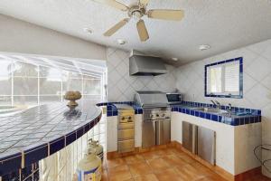 a kitchen with a ceiling fan and a blue counter top at Anna Maria's Finest in Anna Maria