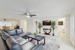 a living room with a blue couch and a table at Anna Maria's Finest in Anna Maria