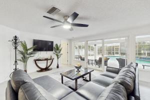 a living room with a couch and a ceiling fan at Anna Maria's Finest in Anna Maria