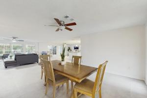 a dining room with a table and chairs and a ceiling fan at Anna Maria's Finest in Anna Maria