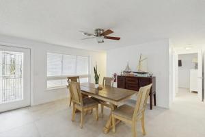 a dining room with a table and chairs and a ceiling fan at Anna Maria's Finest in Anna Maria +16 photos