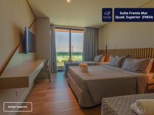 a hotel room with two beds and a couch at Marino Beach Hotel in Cabo Frio +62 photos