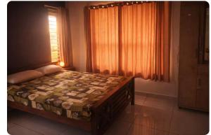 a bedroom with a large bed with a window at Private 3 BHK home in Central Trivandrum with free parking in Trivandrum