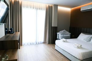 a hotel room with a bed and a large window at Oribu Boutique Hotel Vlore in Vlorë