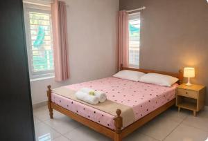 a bedroom with a bed with two towels on it at Private 3 BHK home in Central Trivandrum with free parking in Trivandrum
