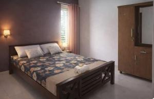 a bedroom with a large bed and a television at Private 3 BHK home in Central Trivandrum with free parking in Trivandrum