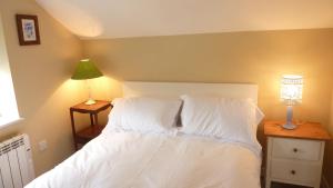 a bedroom with a bed with white sheets and pillows at Eastern Lodge 11B in Lymington