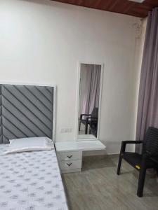 a bedroom with a bed and a mirror at Kohli Farms in Gof +4 photos