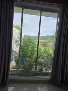 a window with a view of a garden at Kohli Farms in Gof