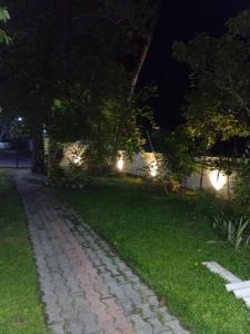 a cobblestone path in a yard at night at 7C Villa in Galle +8 photos