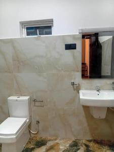 a bathroom with a toilet and a sink at 7C Villa in Galle