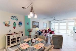 a living room with a table and chairs at Martinique 401S in Holmes Beach