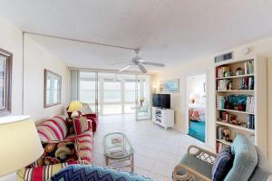 a living room with a couch and a tv at Martinique 401S in Holmes Beach
