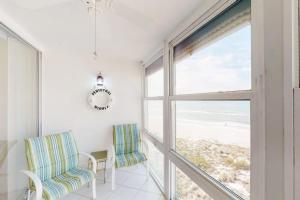 a room with two chairs and a large window at Martinique 401S in Holmes Beach