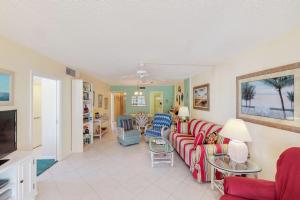 a living room with a couch and a tv at Martinique 401S in Holmes Beach