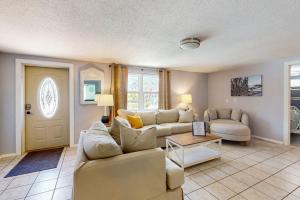 a living room with a couch and a table at Getaway on Gladiolus in Anna Maria