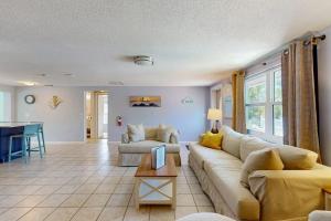 a living room with a couch and a table at Getaway on Gladiolus in Anna Maria