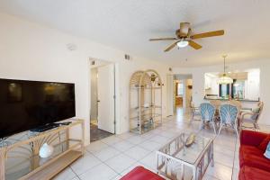 a living room with a couch and a flat screen tv at Shorewalk Villa in Bradenton