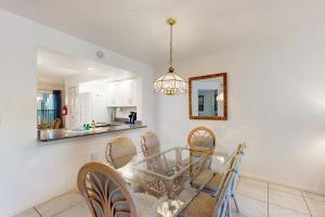 a dining room with a table and chairs and a mirror at Shorewalk Villa in Bradenton +27 photos