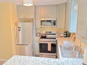 a kitchen with a white refrigerator and a sink at Bethany Pines - 431 Bethany Pines in Bethany Beach