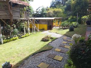 a garden with a path in the grass at Granja Triple A in Guatemala