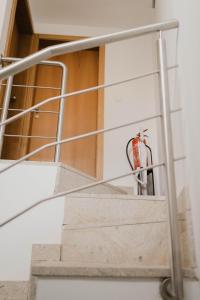 a staircase with a fire extinguisher on the wall at Casa do Foral by Lethes Legacy in Ponte de Lima +28 photos