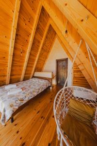 a bedroom with a hammock in a log cabin at Sunrise House in Plužine
