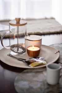 a candle sitting on a table with a plate at Sitios del Sol 1 in General Acha