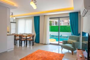 a kitchen and dining room with a table and chairs at Villa A1 Canpare in Fethiye