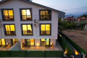 a house with lights in the windows at night at Villa A1 Canpare in Fethiye