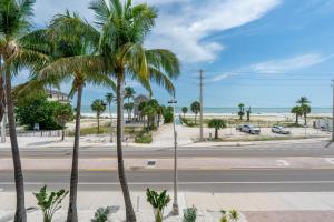 an empty street with palm trees and the beach at White Cap Condo B201 by Sun Palace Vacations in Fort Myers Beach